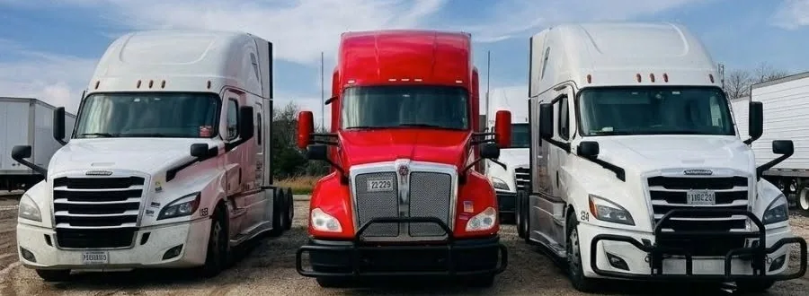 Kenworth and Freightliner tractors at the Express CR Inc Lemont yard